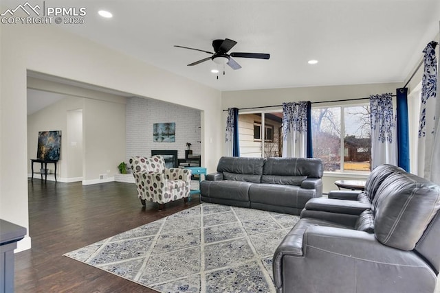 living room featuring a fireplace, baseboards, dark wood-style flooring, and recessed lighting