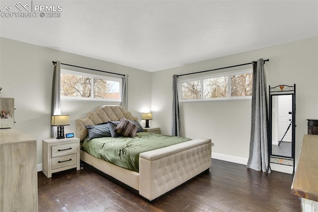 bedroom featuring dark wood finished floors and baseboards