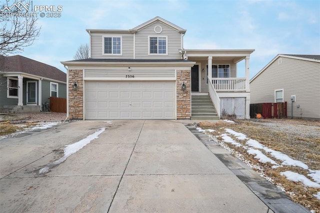 view of front property with covered porch and a garage