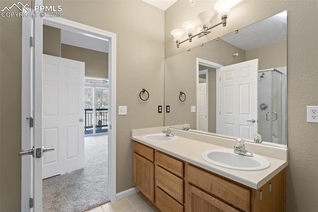 bathroom featuring double vanity, tile patterned floors, a sink, and a shower stall