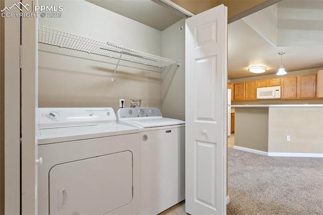 washroom with light carpet, laundry area, independent washer and dryer, and baseboards