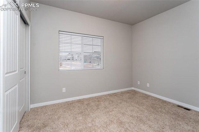 empty room featuring light carpet