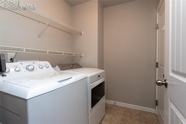 clothes washing area featuring washer and dryer