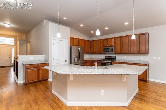 kitchen featuring pendant lighting, stainless steel appliances, a large island, and a breakfast bar area