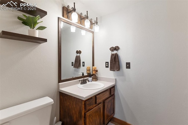 bathroom featuring toilet and vanity