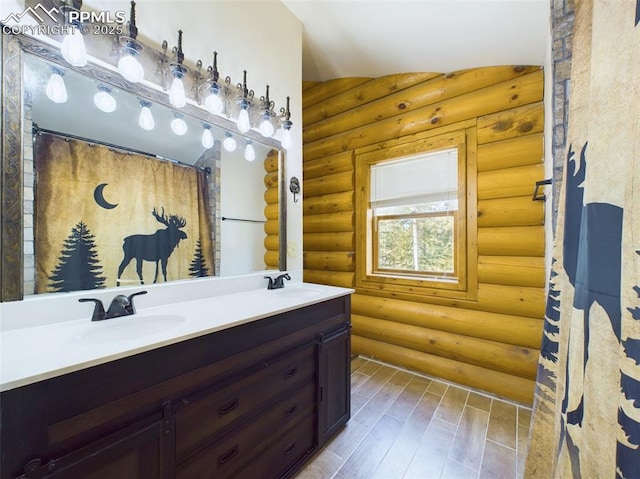 bathroom featuring vanity, log walls, lofted ceiling, and wood-type flooring