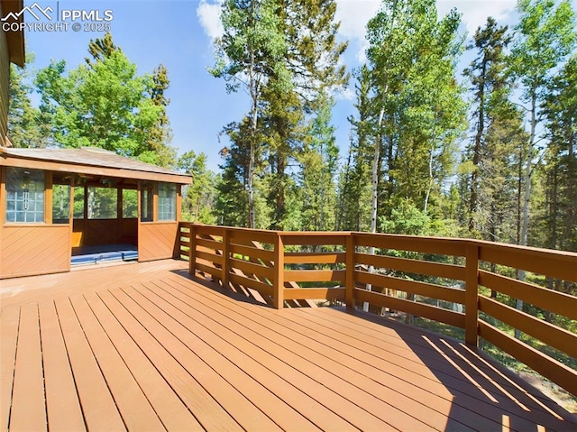 wooden deck featuring a sunroom