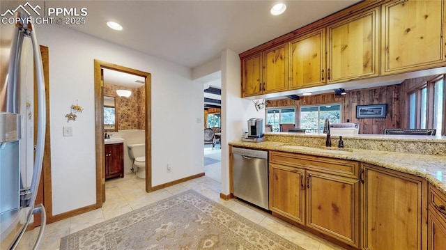 kitchen with fridge with ice dispenser, dishwasher, light stone countertops, light tile patterned flooring, and sink