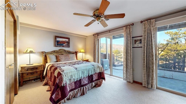 carpeted bedroom featuring ceiling fan, a mountain view, and access to outside