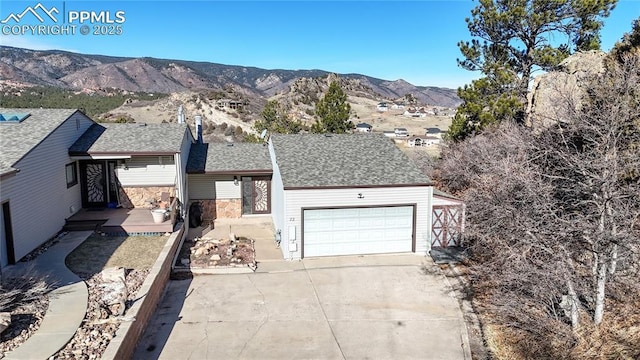 ranch-style house with a mountain view and a garage