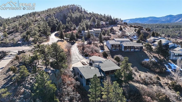 birds eye view of property with a mountain view