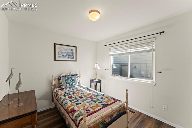 bedroom featuring dark wood-style flooring and baseboards