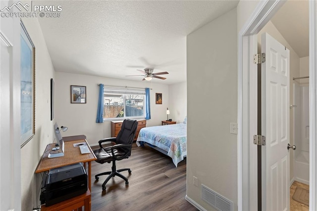 bedroom with a ceiling fan, wood finished floors, baseboards, visible vents, and a textured ceiling