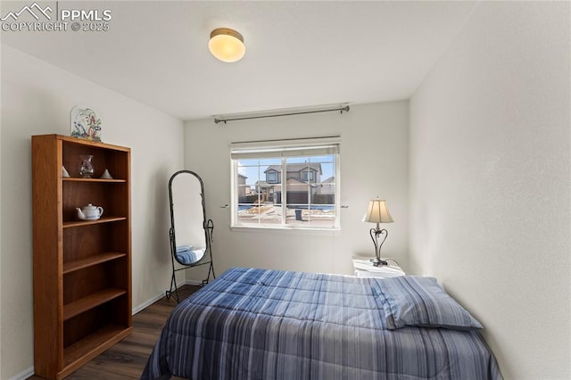 bedroom featuring dark wood-style flooring and baseboards