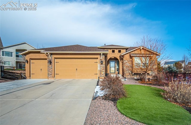 view of front of home with stone siding, driveway, and an attached garage