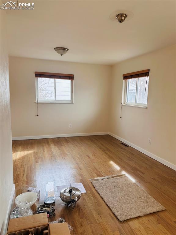 empty room with hardwood / wood-style flooring
