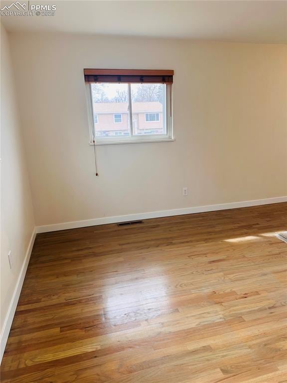 unfurnished room with light hardwood / wood-style flooring