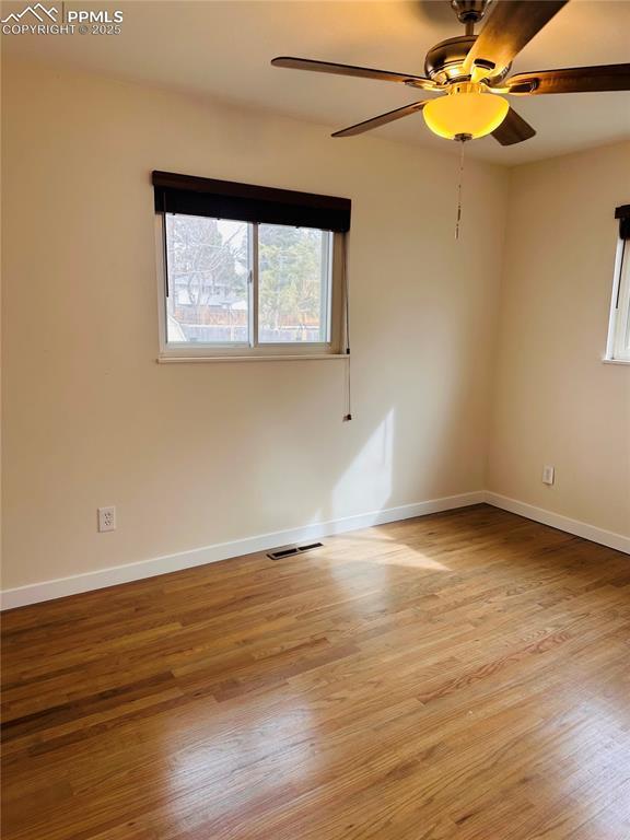 spare room featuring ceiling fan and light hardwood / wood-style flooring