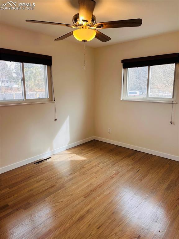 unfurnished room with a wealth of natural light and light hardwood / wood-style floors