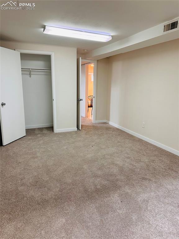 unfurnished bedroom with carpet floors and a closet