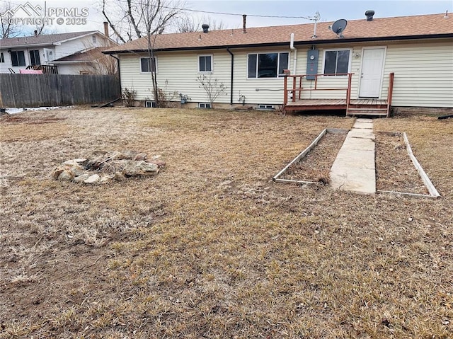 rear view of property featuring a wooden deck