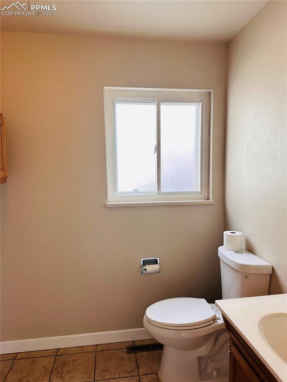 bathroom with tile patterned floors, vanity, and toilet