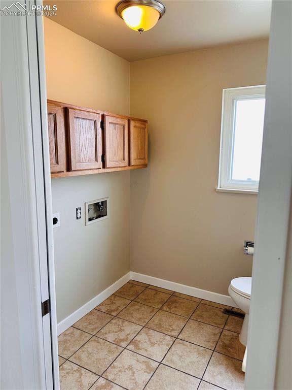 laundry room featuring washer hookup, hookup for an electric dryer, and light tile patterned flooring