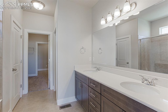 bathroom with vanity, tile patterned floors, and walk in shower