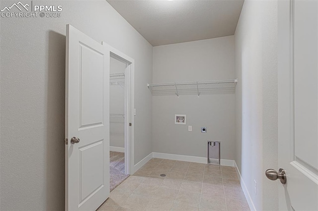 laundry room with electric dryer hookup, hookup for a washing machine, and light tile patterned flooring