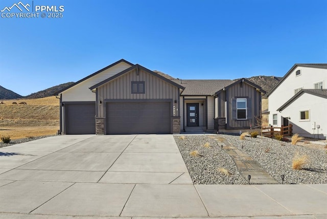 view of front of property featuring a garage and a mountain view