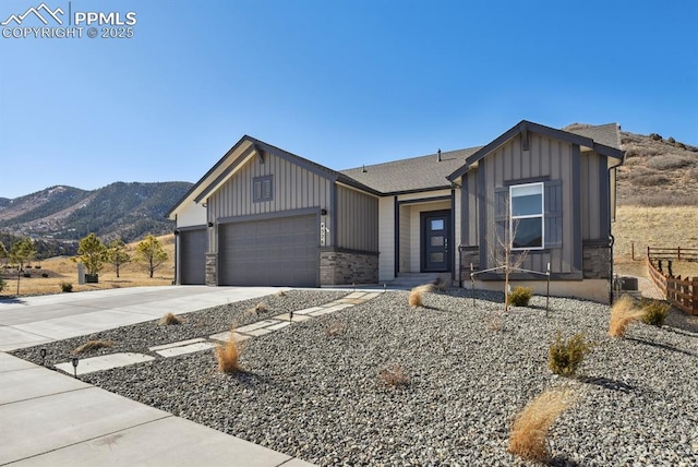 view of front facade featuring a garage and a mountain view