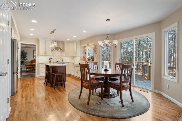 dining room featuring an inviting chandelier and light hardwood / wood-style flooring