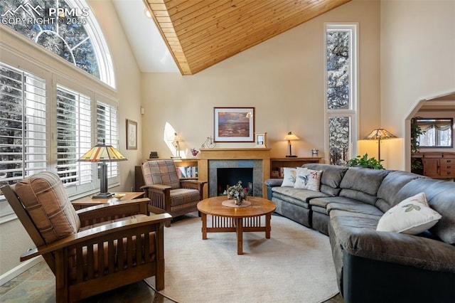 living room with high vaulted ceiling and wood ceiling