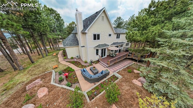 rear view of property with a lawn, an outdoor living space, and a wooden deck