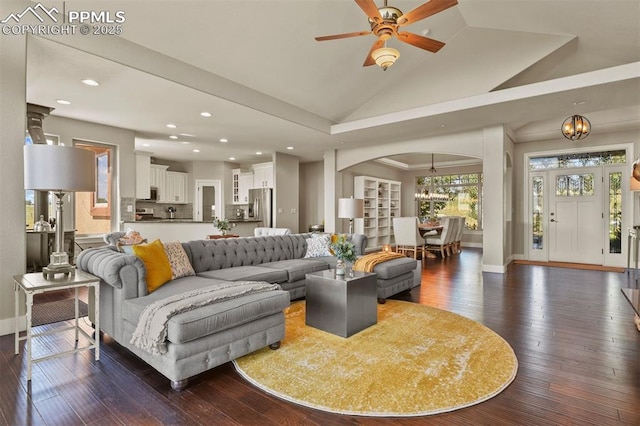 living room featuring ceiling fan with notable chandelier, high vaulted ceiling, and dark hardwood / wood-style flooring