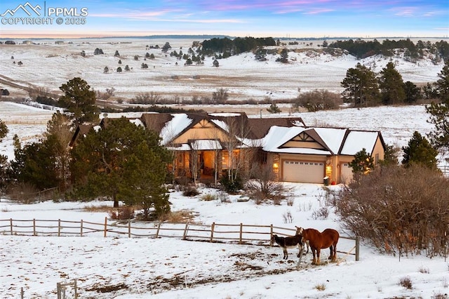 exterior space featuring a rural view and a garage