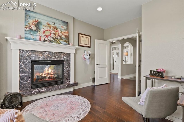 living room featuring a fireplace and dark hardwood / wood-style floors