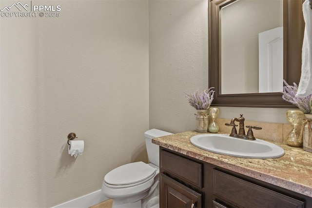 bathroom featuring toilet and vanity