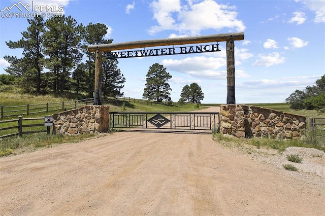 view of gate with a rural view