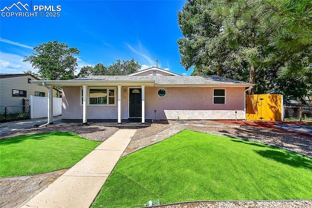 single story home with fence, a front lawn, and stucco siding