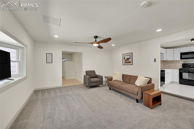 living area with recessed lighting, light colored carpet, a ceiling fan, baseboards, and visible vents