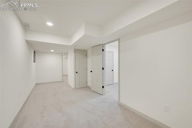unfurnished room with baseboards, recessed lighting, visible vents, and light colored carpet