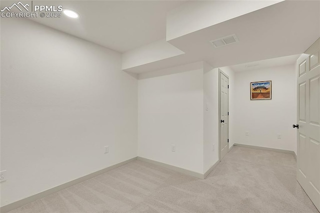 spare room with recessed lighting, visible vents, light carpet, and baseboards