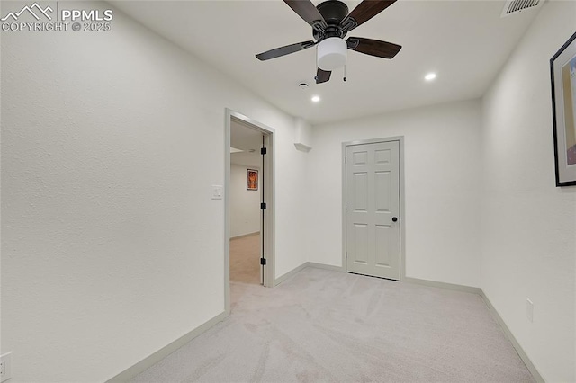 spare room featuring recessed lighting, light colored carpet, a ceiling fan, baseboards, and visible vents