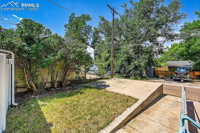 view of yard featuring a patio area and fence