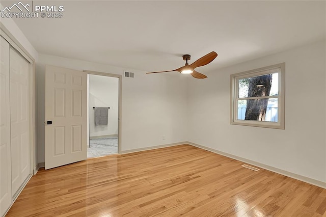 unfurnished bedroom with a closet, light wood-type flooring, visible vents, and baseboards