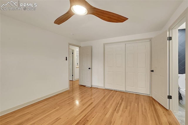 unfurnished bedroom with ceiling fan, a closet, light wood-type flooring, and baseboards
