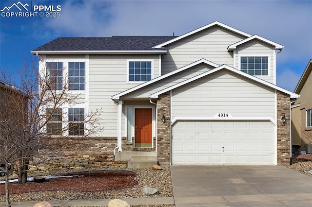 traditional home featuring a garage, brick siding, roof with shingles, and concrete driveway