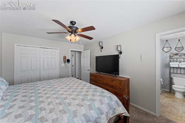 carpeted bedroom with ensuite bathroom, ceiling fan, and a closet