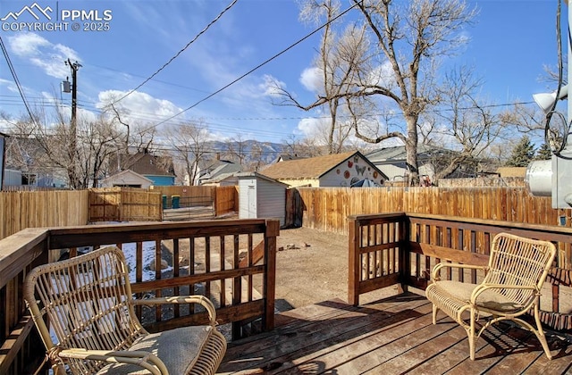 wooden deck featuring a storage unit